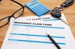 Insurance Claim Form With Car Key Stock Photo