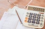 Calculator, Pen And Eyeglasses On Bank Account Passbook Stock Photo