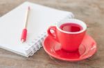 Red Mug With Open Notebook Stock Photo