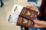 Two Of Thailand Passports In Hands With Boarding Passes Stock Photo