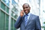 Businessman Communicating Over Phone Stock Photo