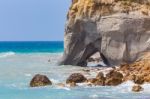 Rock With Cave In Sea At Greek Coast Stock Photo