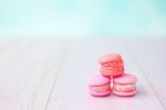 Colorful Macarons On A Pink Wooden Table Stock Photo