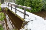 Wooden Bridge Covered With Snow In Winter Stock Photo