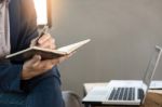 Thoughtful Young Business Man In Casual Shirt Holding Note Pad Stock Photo