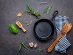 Empty Old Cast Iron Skille On Dark Stone Background. Ingredients Stock Photo