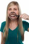 Young Girl Playing Around With Magnifying Glass Stock Photo