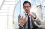 Asia Business Man Using A Mobile Phone Stock Photo