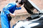 Mechanic Checking The Motor Oil Of The Car Stock Photo