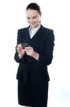 Confident Businessperson Messaging Stock Photo