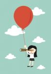 Business Concept, Business Woman Using Her Telescope Looking For Something In The Sky While Flying With Big Balloon Stock Photo