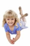 Sweet Little Girl Posing Relaxed On The Floor Stock Photo