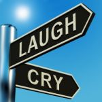 Laugh Or Cry Signpost Stock Photo