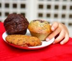 Kid Stealing Muffin From Table Stock Photo