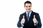 Handsome Businessman Holds His Thumbs Up Stock Photo