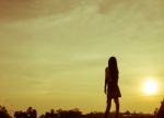 Silhouette Of Woman Praying Over Beautiful Sky Background Stock Photo