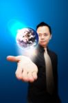 Asia Business Man Holding Globe Stock Photo