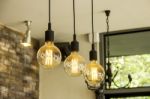 Glowing Retro Light Bulbs Hanging From Ceiling Stock Photo