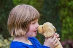 Young Girl Hugging Stuffed Dog Stock Photo