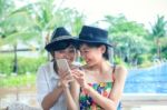 Portrait Of Young Beautiful Asian Woman Laughing With Happiness Face Looking To Smart Phone Use For People And Digital Modern Life Connecting On Line By Mobile Phone Chat Stock Photo