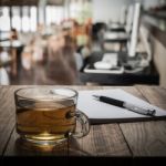 Hot Tea With Notebook And Pen On Wooden Table Stock Photo