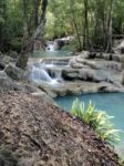 Waterfall Flowing Into The Water Is Blue Stock Photo