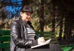 Young Beautiful Woman Writing A Pen In Notebook Stock Photo