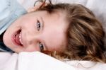 Young Girl Lying On Sofa Laughing Stock Photo