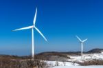 Wind Turbine And Blue Sky In Winter Landscape Stock Photo