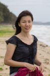 Woman Smiling On A Tropical Beach Stock Photo