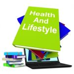 Health And Lifestyle Book Stack Laptop Shows Healthy Living Stock Photo