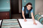 Housekeeping Staff Rearranging Room Stock Photo