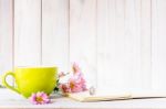 Notebook With A Pencil On The Table Next To Coffee And Flowers Stock Photo