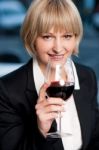 Corporate Lady Drinking Red Wine Stock Photo