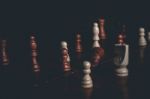 Chess Pieces On A Chess Board Background Stock Photo