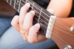 Guitarist Hand Playing Acoustic Guitar Stock Photo