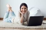 Beautiful Young Woman Working On Her Laptop At Home Stock Photo