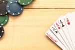 Cards And Poker Chips On Wooden Background Stock Photo