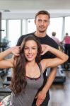 Woman With Personal Trainer  In Gym Stock Photo