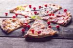 Cutted Pizza On Wooden Table Stock Photo