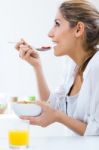 Woman Eating Cereals In The Morning Stock Photo