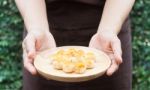 Traditional Chinese Yellow Mini Cakes On Hand Of Baker Stock Photo