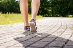 Female Feet On The Sidewalk Closeup Stock Photo