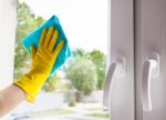 Woman Washing The Window Stock Photo