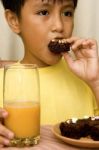 Kid Eating Brownies Stock Photo