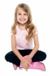 Pretty Caucasian Girl Seated On Floor Stock Photo