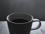 Black Coffee In White Ceramic Cup With Hot Smoke Floating Stock Photo