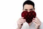 Handsome Man Holding Heart Shape Gift Box Stock Photo