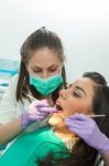 Dentist Examining A Patient's Teeth In The Dentist Stock Photo