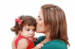 Happy Mother Kissing Her Daughter, Isolated On White Background Stock Photo